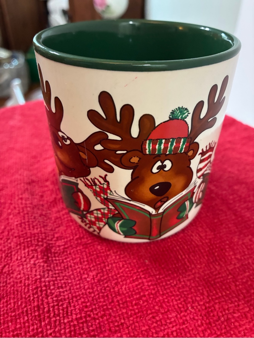 Vintage 1990 Christmas mug featuring a comical caroling reindeer